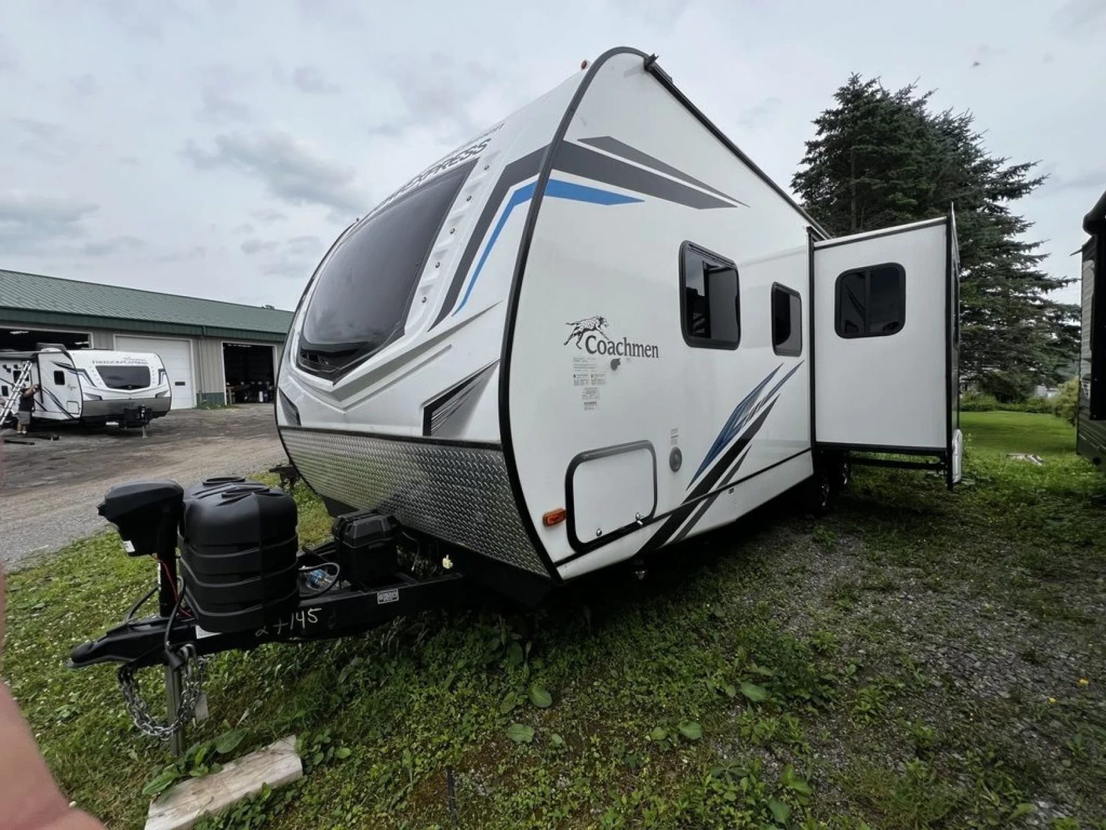 A Coachmen Freedom Express travel trailer with its slide out on the Lime Lake lot