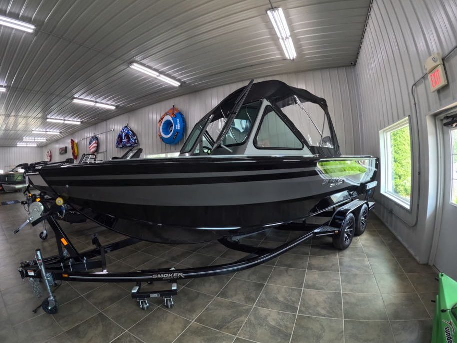 A Smoker Craft fishing boat with its top up in the Lime Lake showroom
