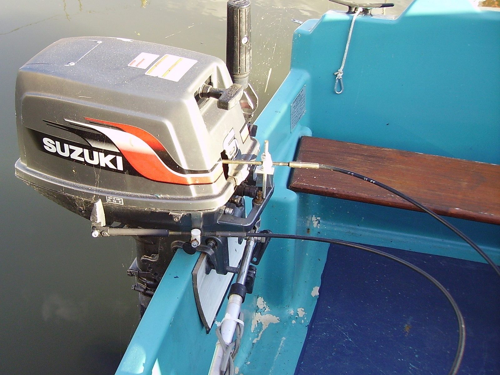 A Suzuki outboard on the transom of a small boat