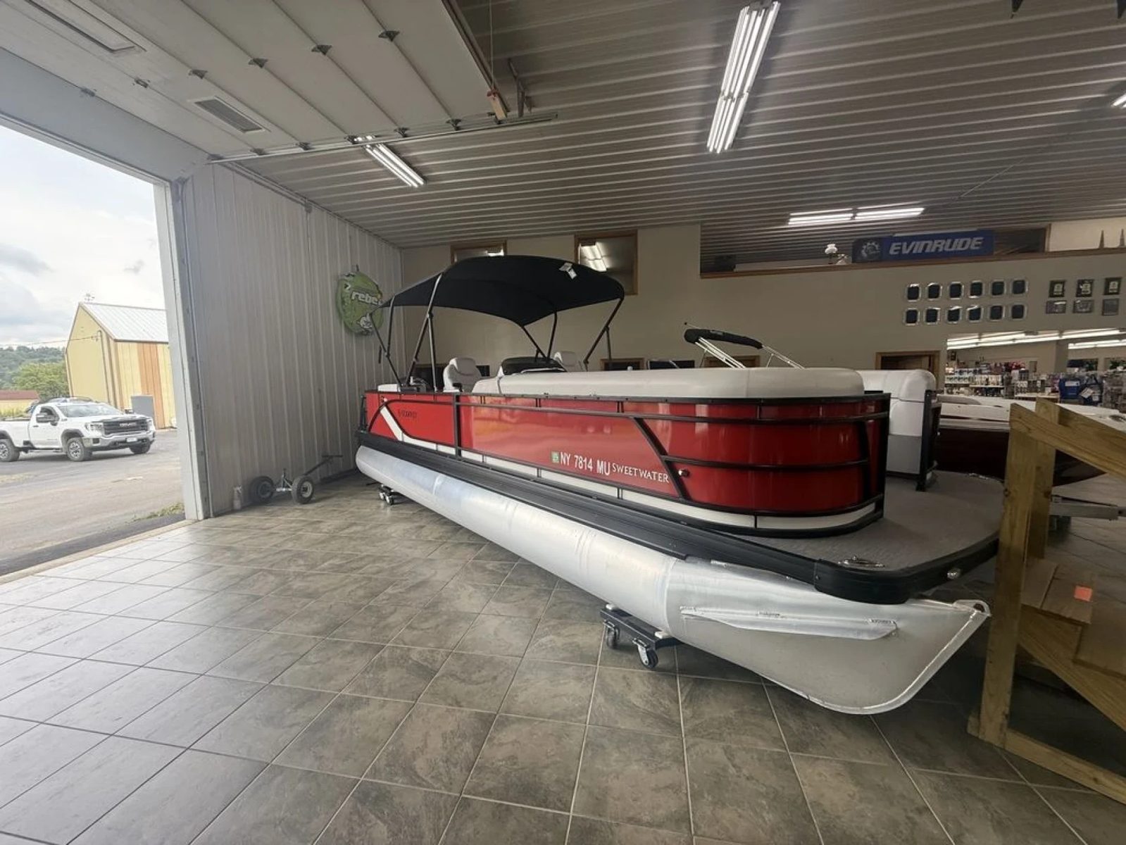 A red Sweetwater pontoon in the Lime Lake showroom