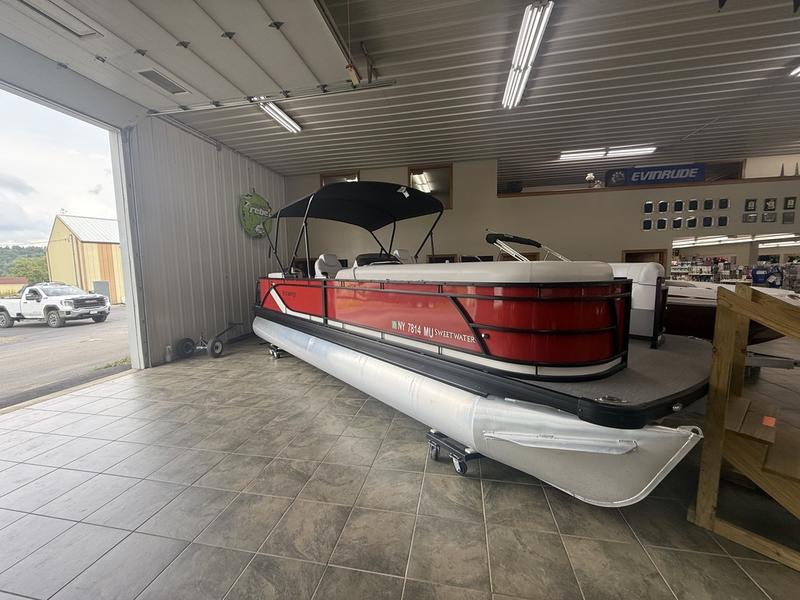 A red pontoon boat in the Lime Lake Marine & RV showroom