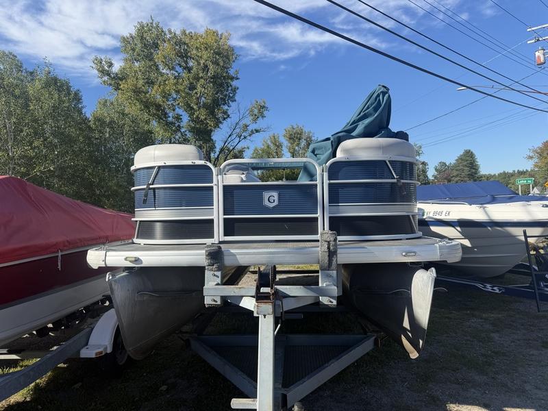A pre-owned pontoon on a trailer on the Lime Lake lot